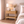Bedroom with wooden nightstand, lamp, and decorative items.