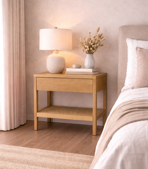 Bedroom with wooden nightstand, lamp, and decorative items.