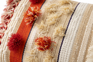 Close-up of a textured fabric with floral patterns and color stripes.
