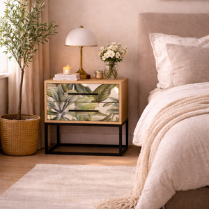 Neatly arranged bedroom with a nightstand, bed, and decorative elements.