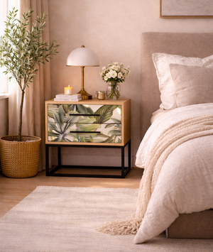 Neatly arranged bedroom with a nightstand, bed, and decorative elements.